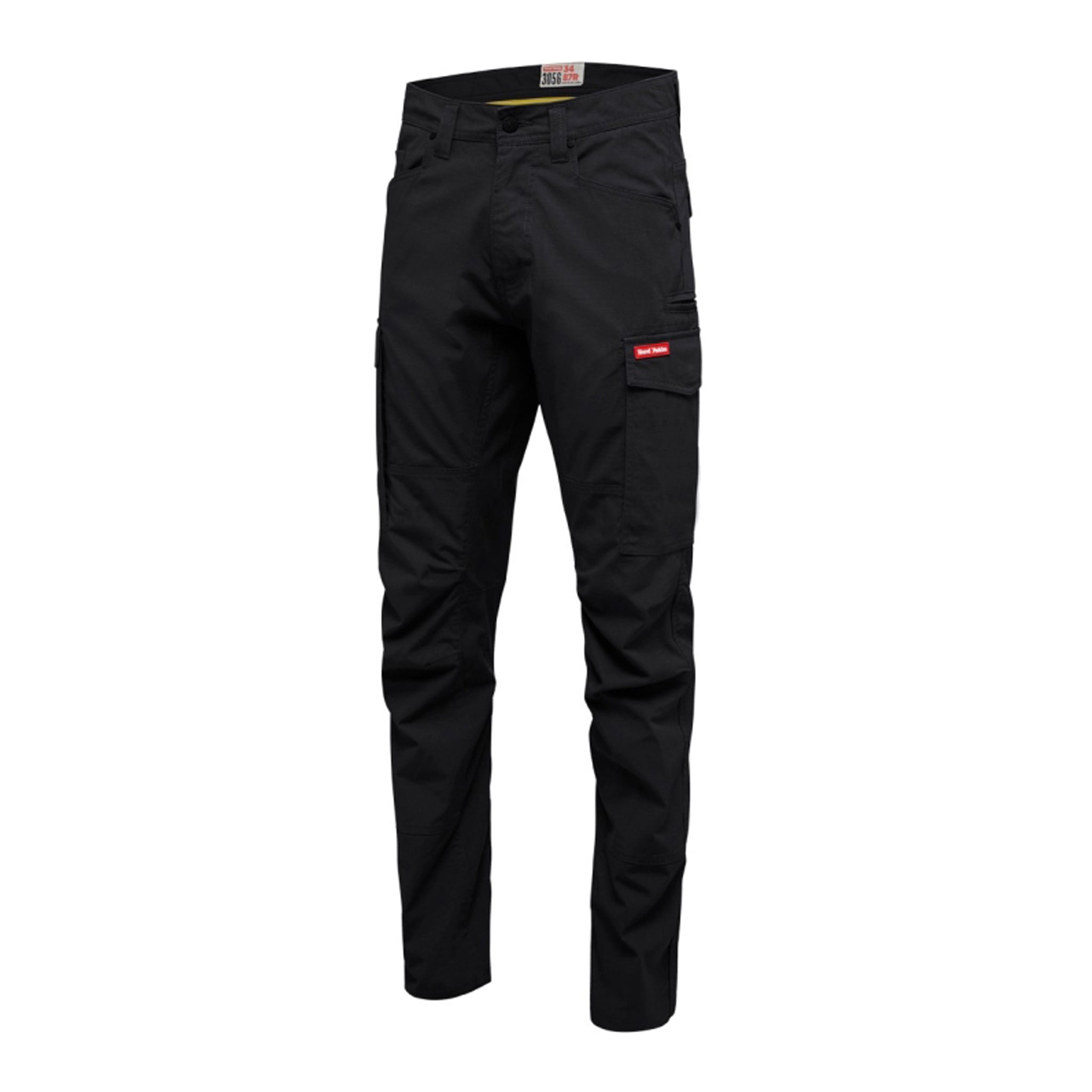 Black work pants with a large flapped Hard Yakka pocket, buttoned waist, and straight-cut ankles.