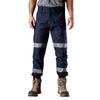 navy blue full length worksite pants with buttoned waist and belt loops. large pockets with hi-vis bands and elastic cuffs at the ankles