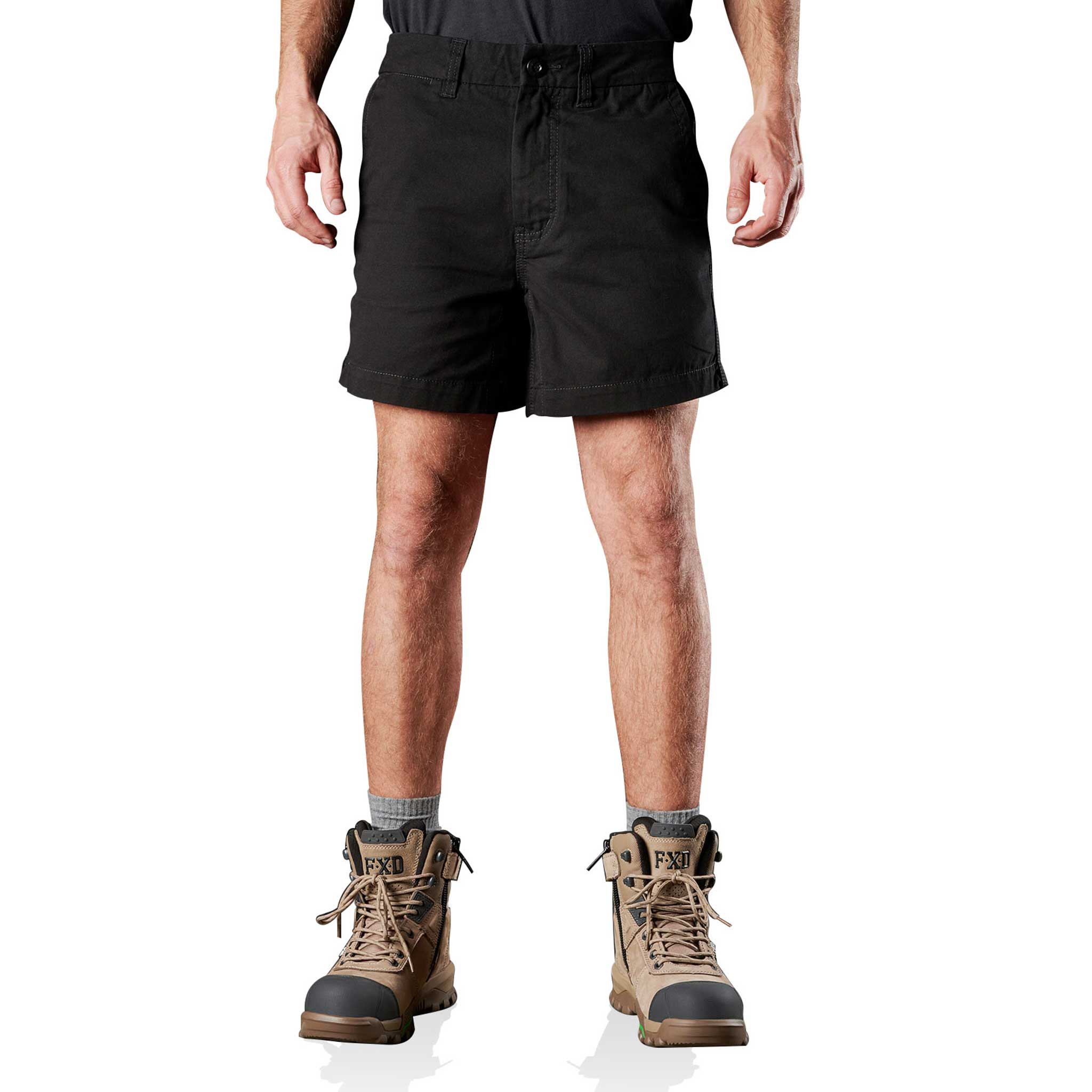 A person standing and wearing black cotton twill work shorts