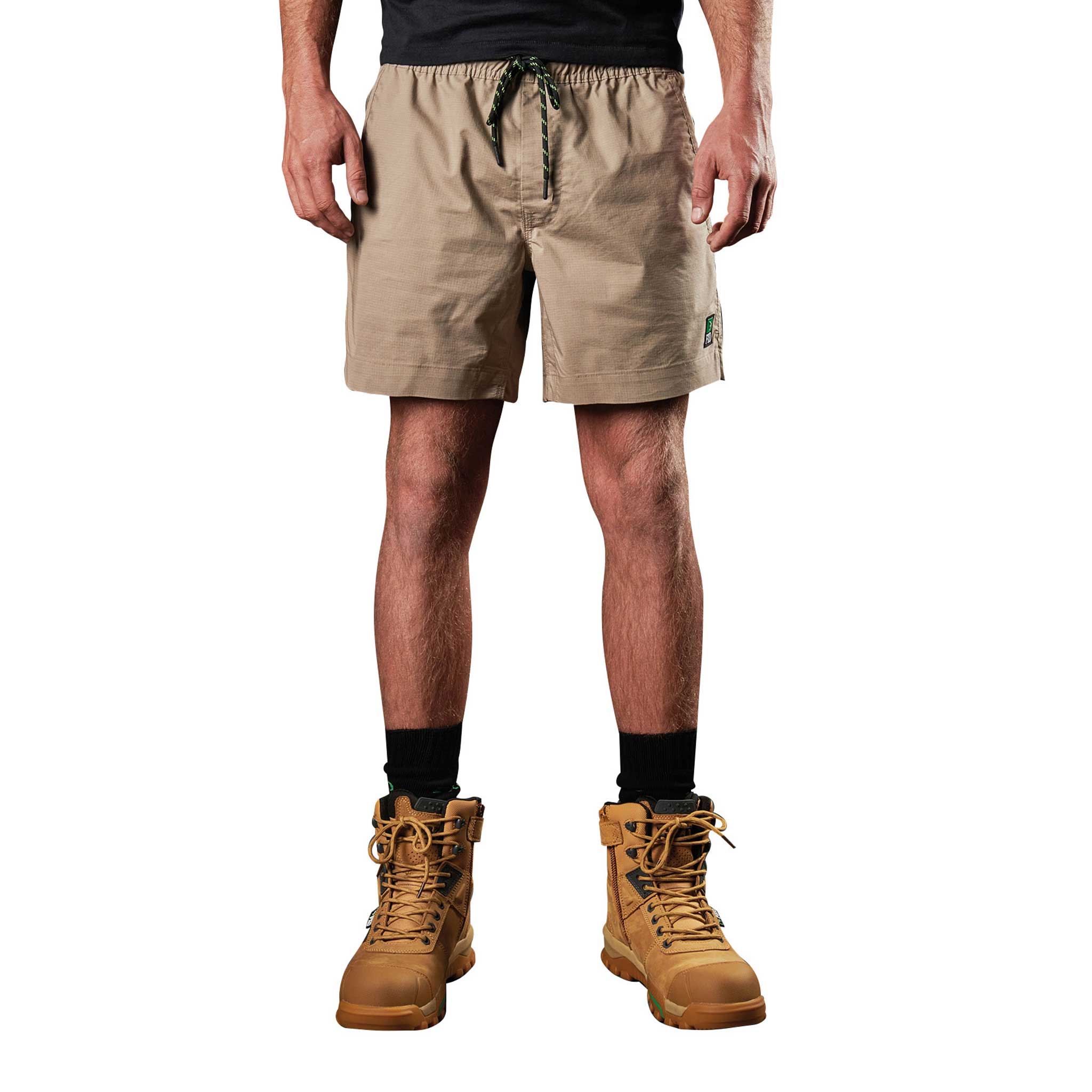 A man wearing FXD Elastic waist work shorts in khaki