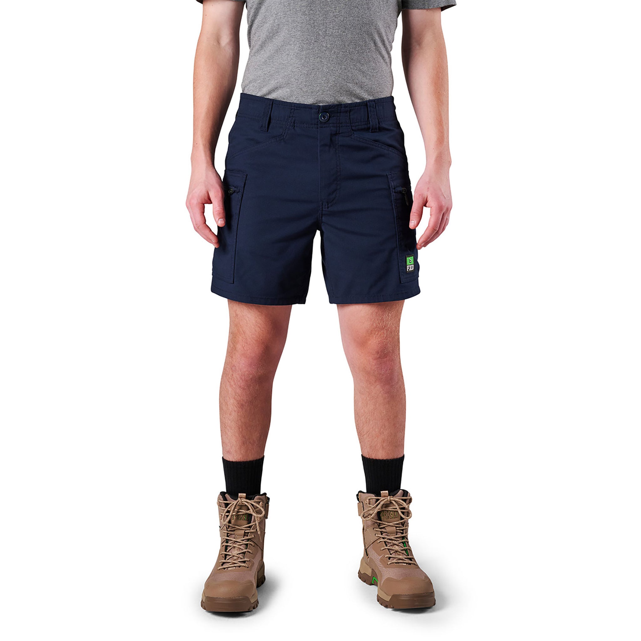 A man wearing FXD comfort stretch cargo work short in navy