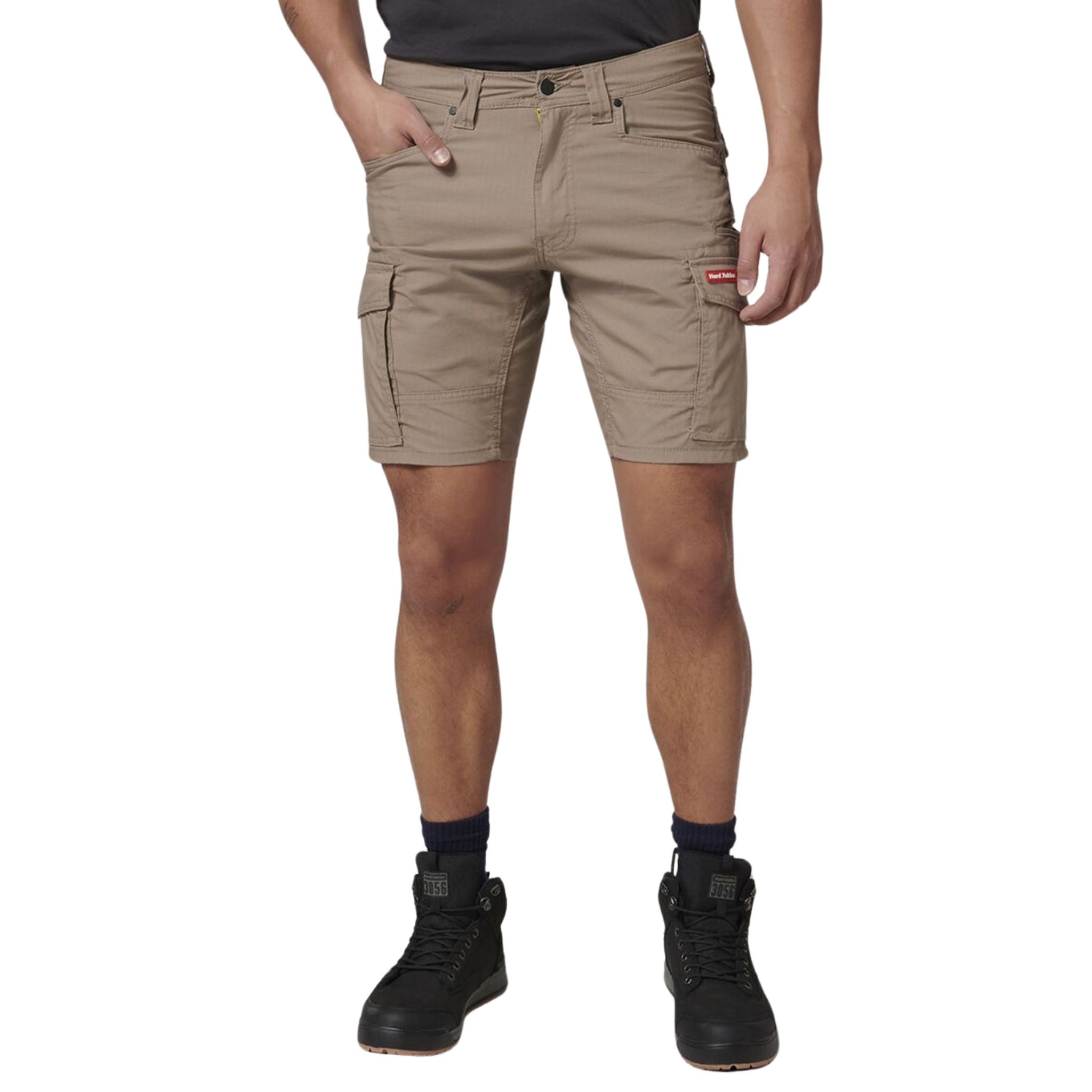 A man wearing Hard Yakka Ripstop cargo work shorts in desert