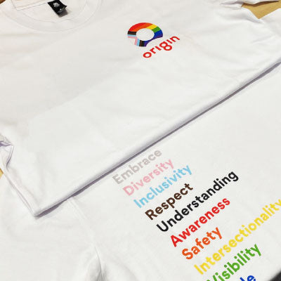 White t-shirt with rainbow-colored text and Origin logo